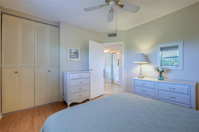 a spacious bedroom with a bed and a dresser