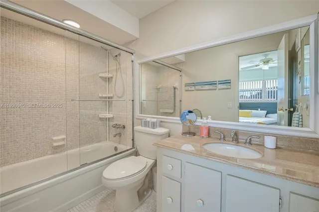 a bathroom with a granite countertop toilet a sink and a bathtub