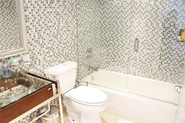 a bathroom with a toilet and a shower curtain