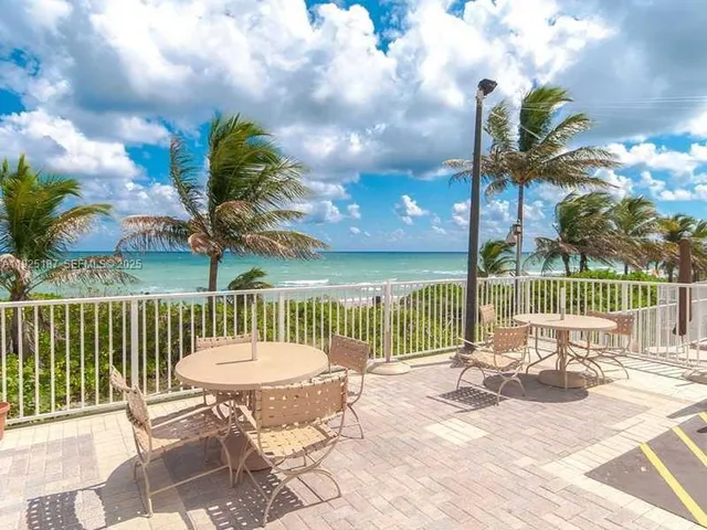 a view of a balcony dining table and chairs