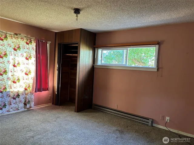 an empty room with a fireplace and painted walls