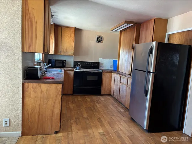 a kitchen with stainless steel appliances a refrigerator stove and sink