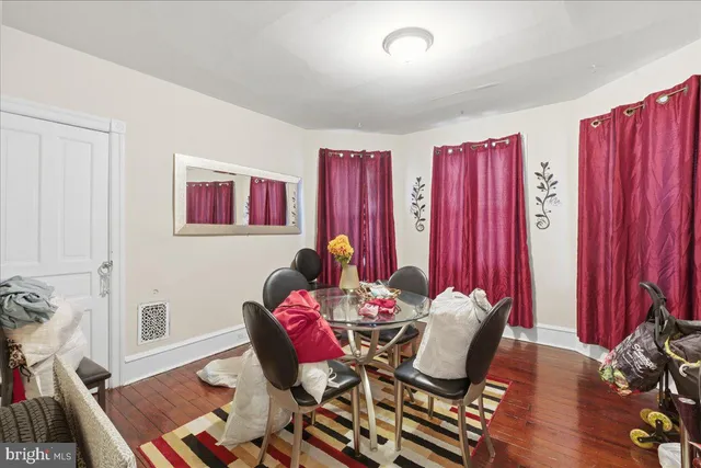 a dining room with furniture and wooden floor