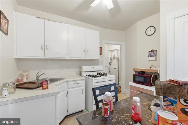a kitchen with a refrigerator and a stove top oven