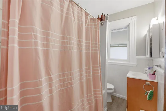 a bathroom with a shower curtain and a sink