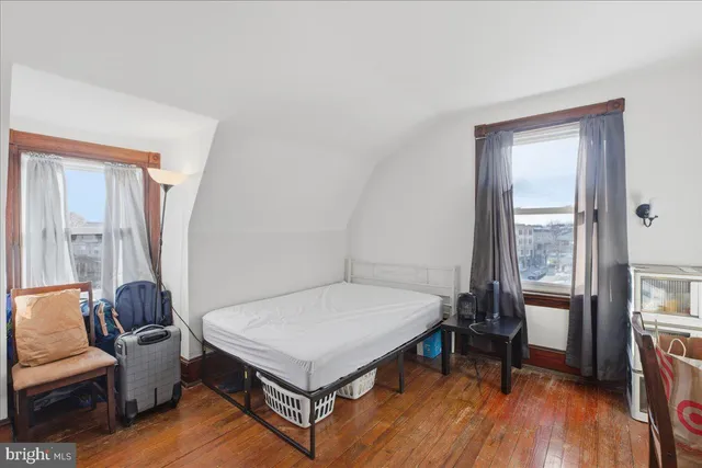 a living room with a bed furniture and a window