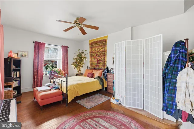 a bedroom with a bed and a book shelf