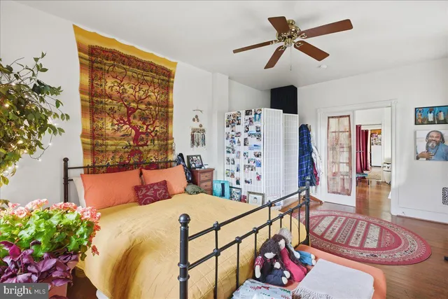 a bedroom with bed and a chandelier