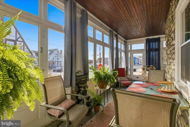 a balcony with furniture and potted plants