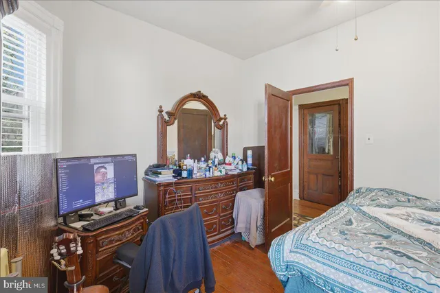 a bedroom with a bed and a dresser