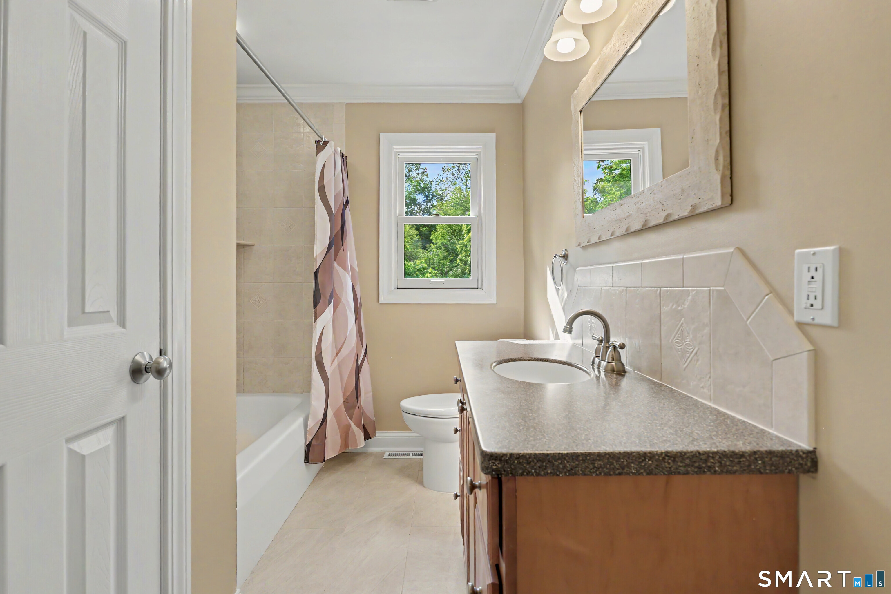 632 Wheelers Farm Road Orange, CT 06477 - Photo 23 of 39 a bathroom with a sink a vanity and a window