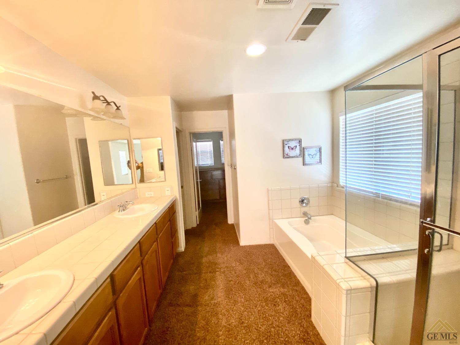 Undisclosed Address Bakersfield, CA 93312 - Photo 17 of 38 a spacious bathroom with a tub and shower