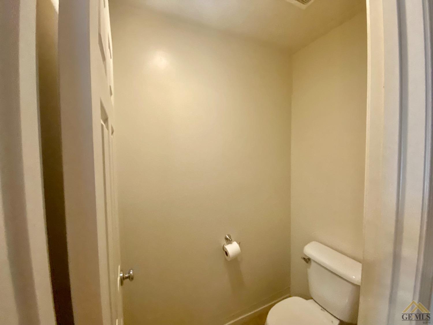Undisclosed Address Bakersfield, CA 93312 - Photo 24 of 38 a white toilet sitting next to a shower curtain