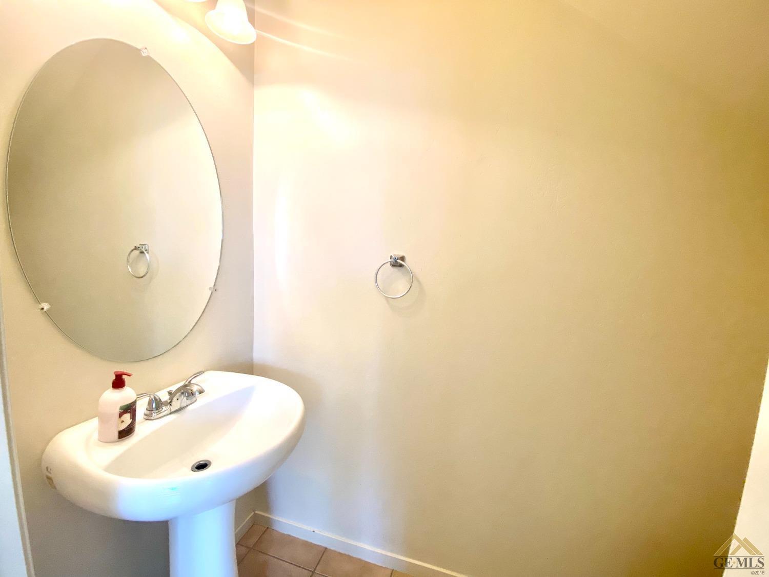 Undisclosed Address Bakersfield, CA 93312 - Photo 31 of 38 a bathroom with a sink and a mirror