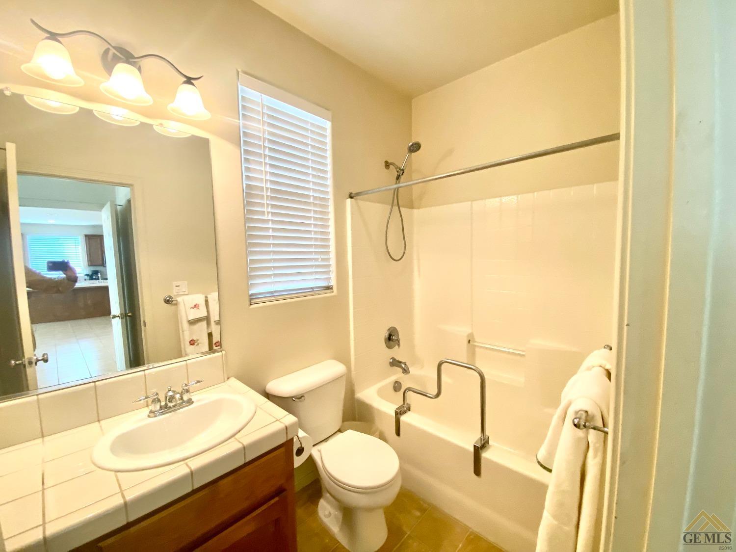 Undisclosed Address Bakersfield, CA 93312 - Photo 33 of 38 a bathroom with a sink vanity mirror and toilet
