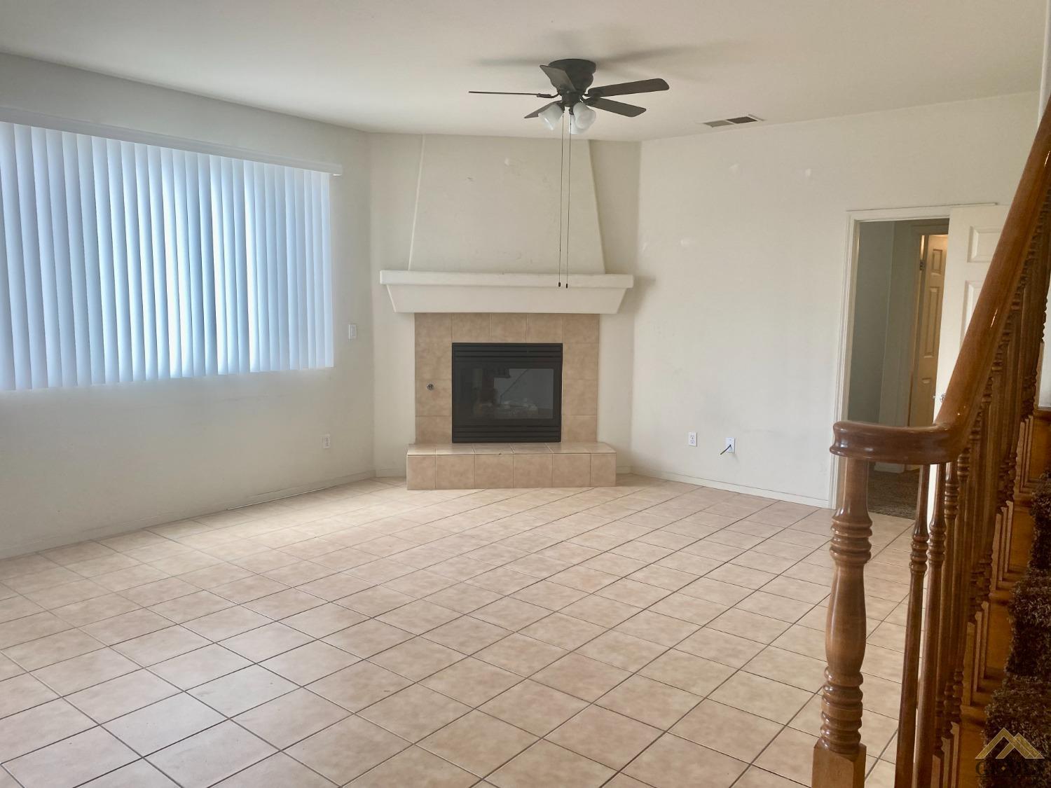 Undisclosed Address Bakersfield, CA 93312 - Photo 5 of 38 a view of empty room with wooden floor and fireplace