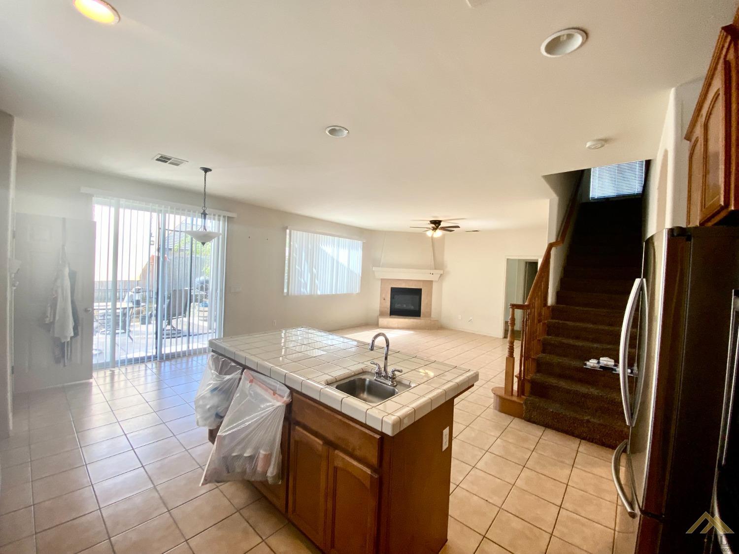 Undisclosed Address Bakersfield, CA 93312 - Photo 6 of 38 a kitchen with a stove a refrigerator and a sink