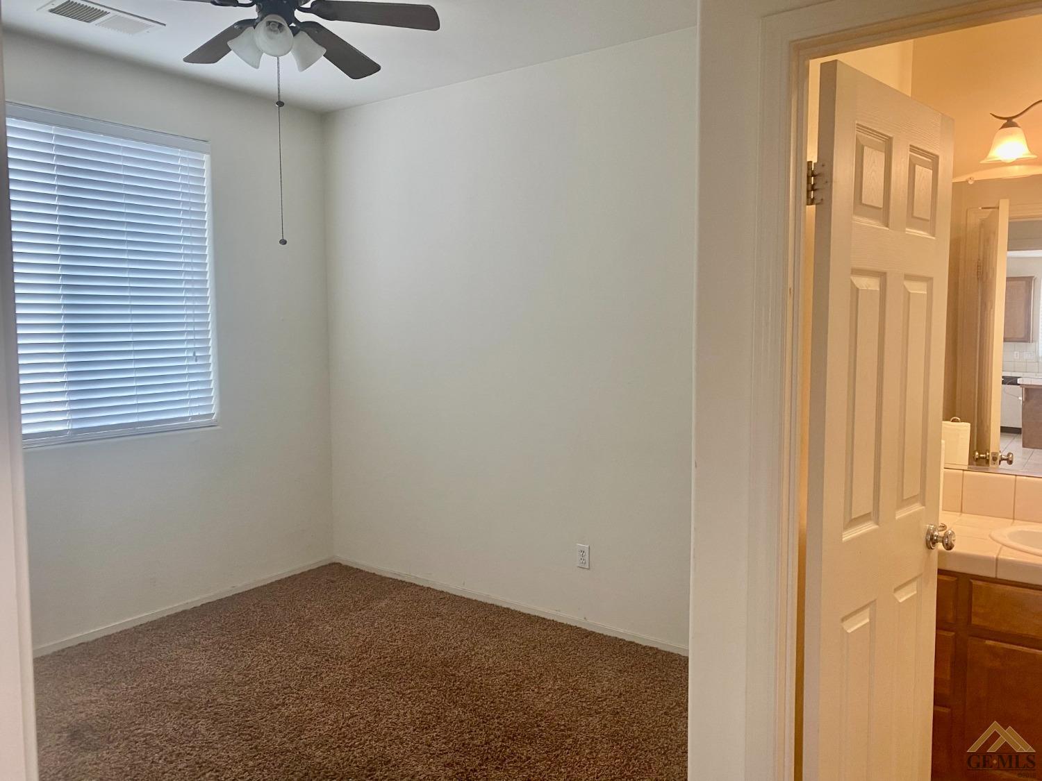 Undisclosed Address Bakersfield, CA 93312 - Photo 7 of 38 a view of an empty room with a window