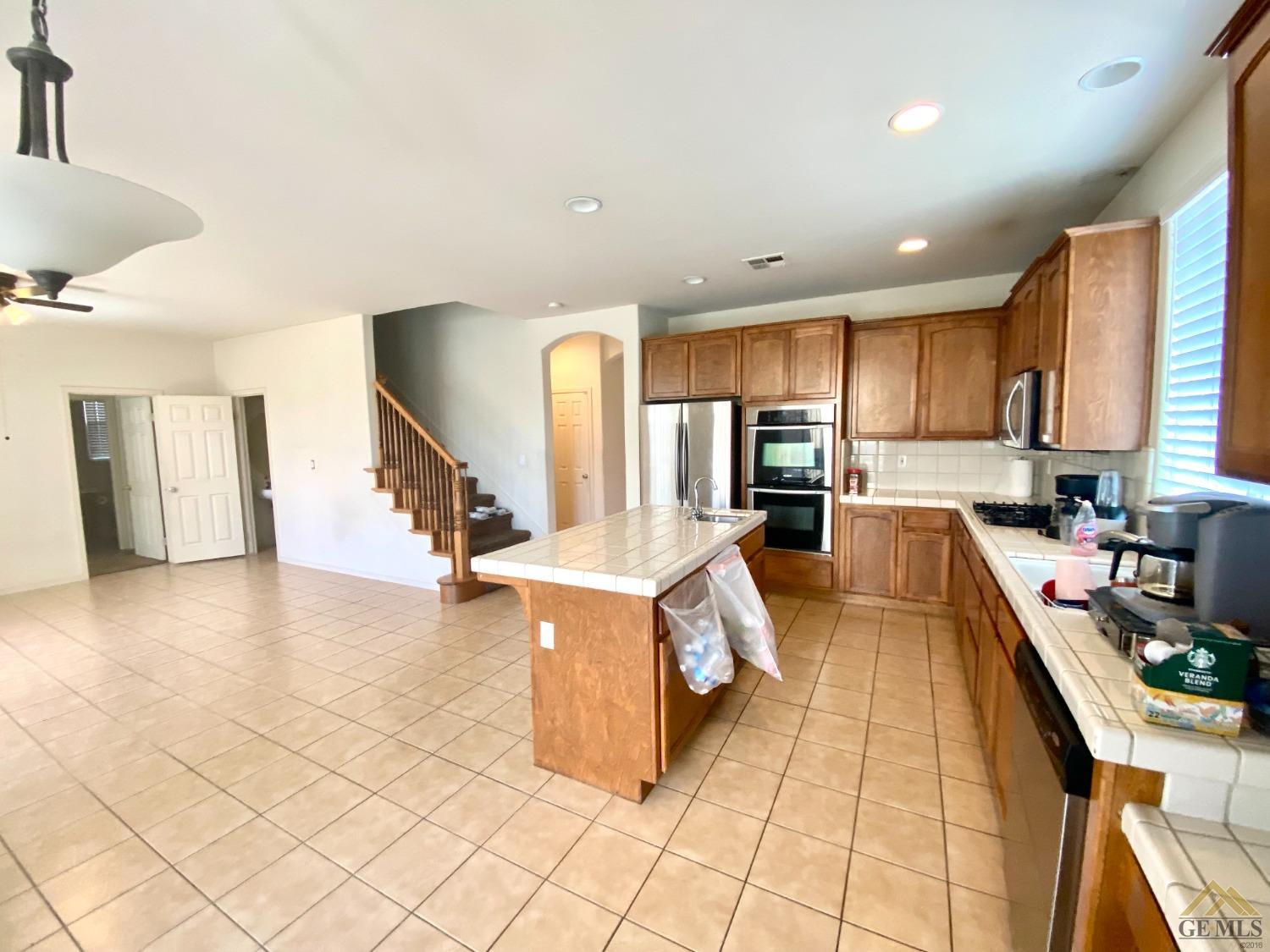 Undisclosed Address Bakersfield, CA 93312 - Photo 10 of 38 a kitchen with stainless steel appliances granite countertop a sink and cabinets