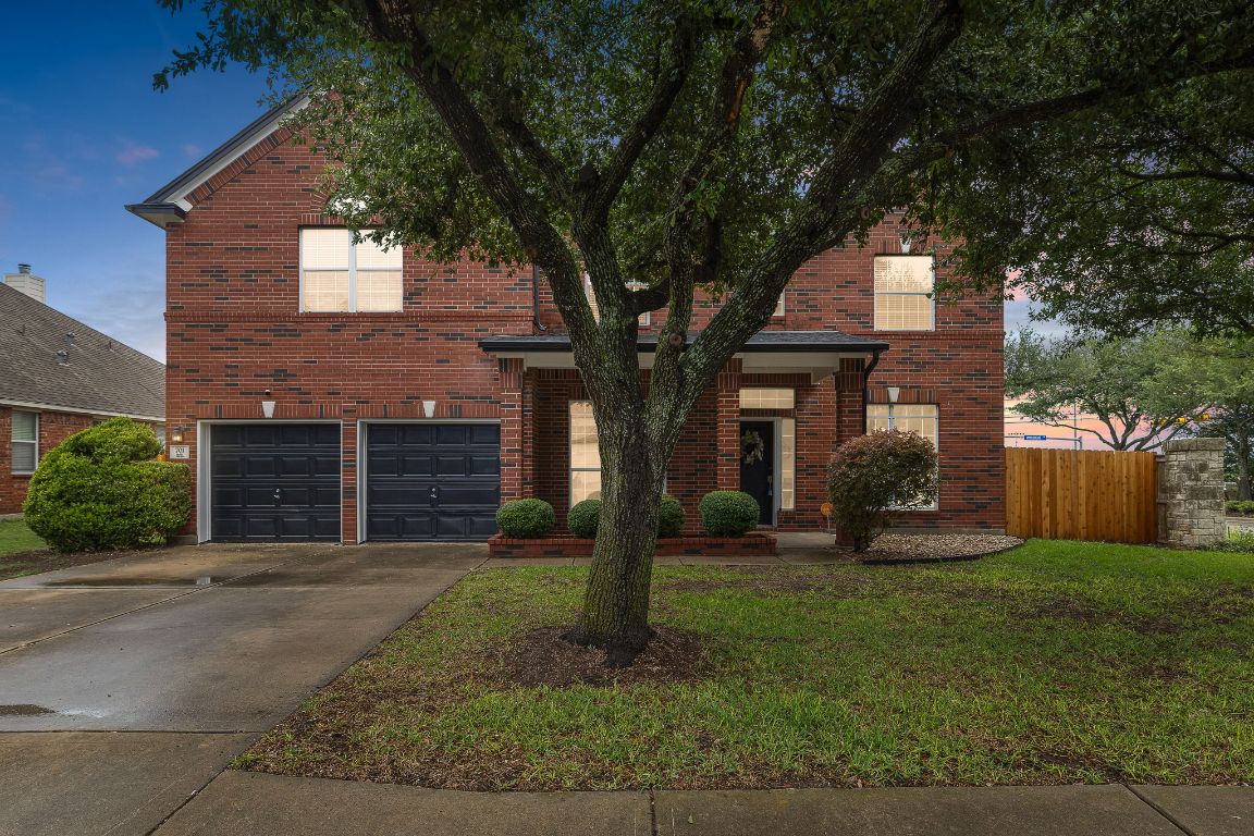 a front view of a house with a yard and garage