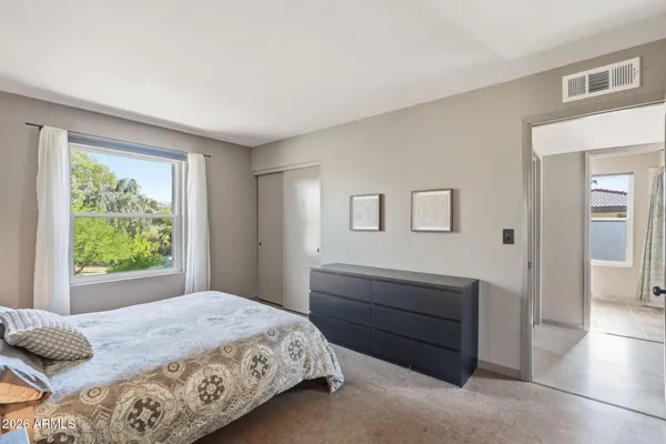 a bedroom with a bed and a window