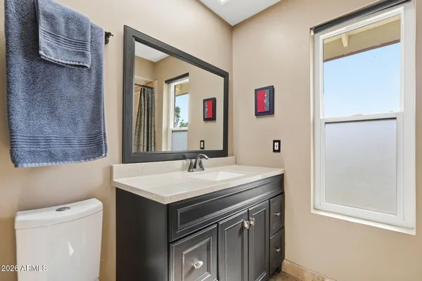 a bathroom with a sink vanity and a mirror