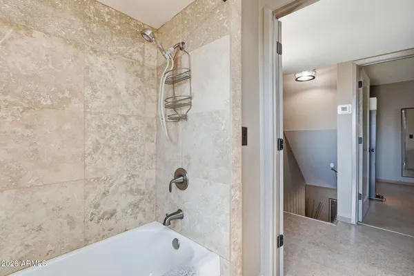 a bathroom with a bathtub and shower