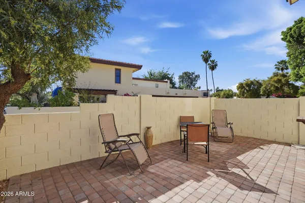 a view of a chairs and table in patio