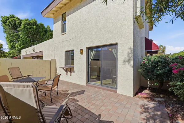 a view of a patio with table and chairs and potted plants