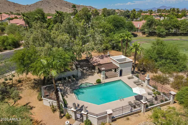 an aerial view of a house with a garden and lake view