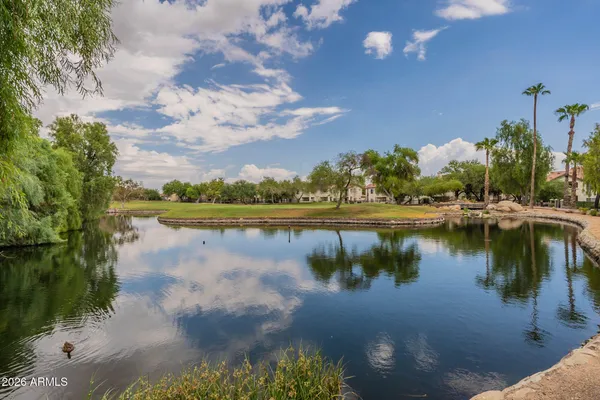 a view of a lake with houses in the back