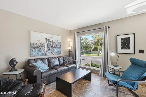 a living room with furniture and a large window