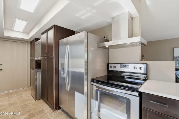 a kitchen with a refrigerator and a stove top oven