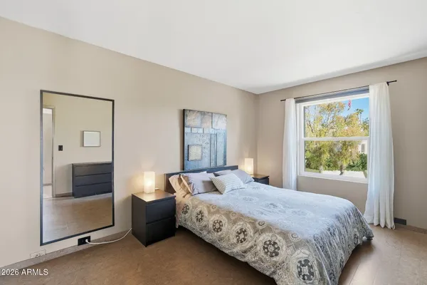 a bedroom with a large bed and a window