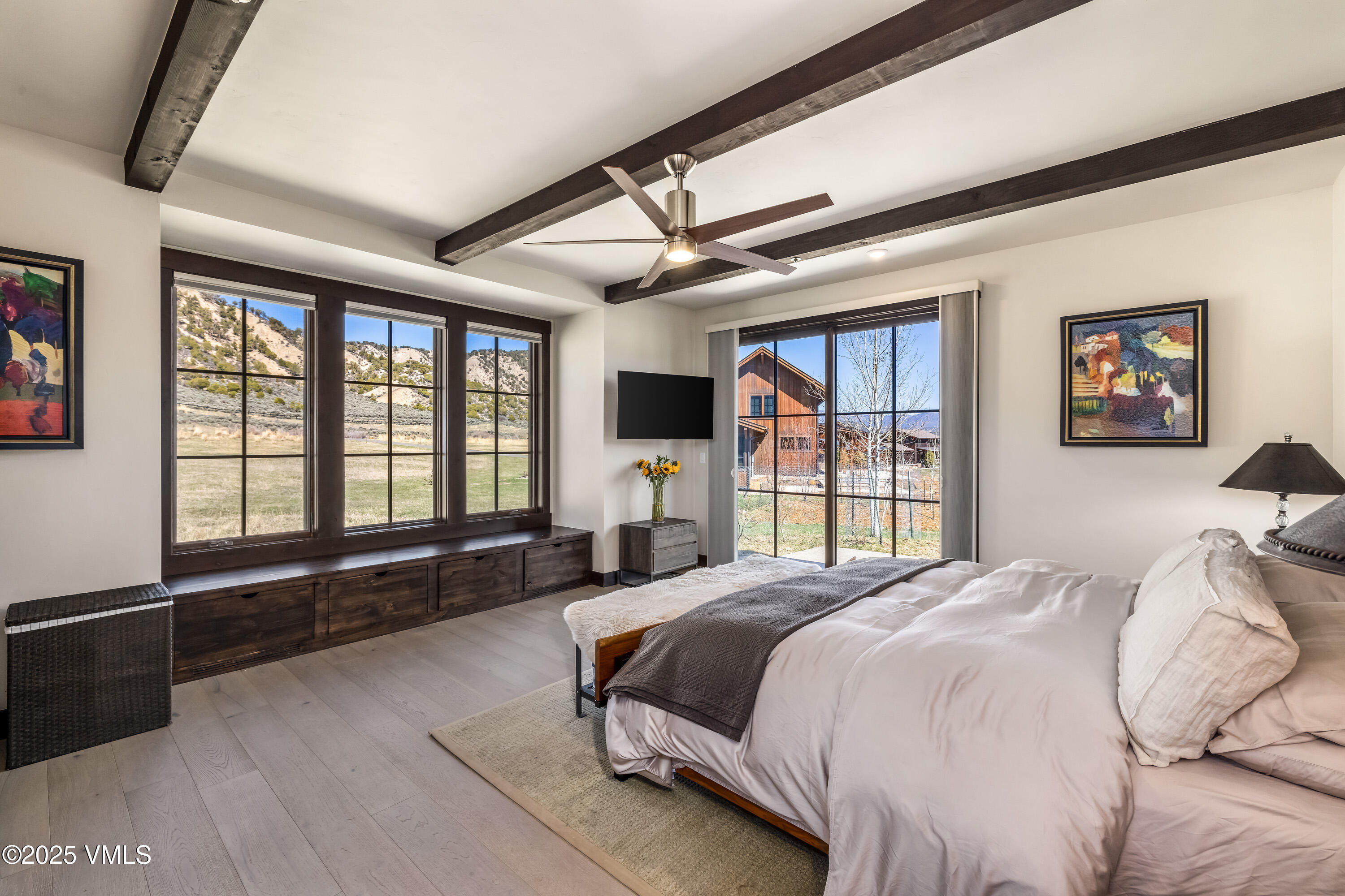140 Hunters View Lane Eagle, CO 81631 - Photo 14 of 38 a spacious bedroom with a large bed and a large window