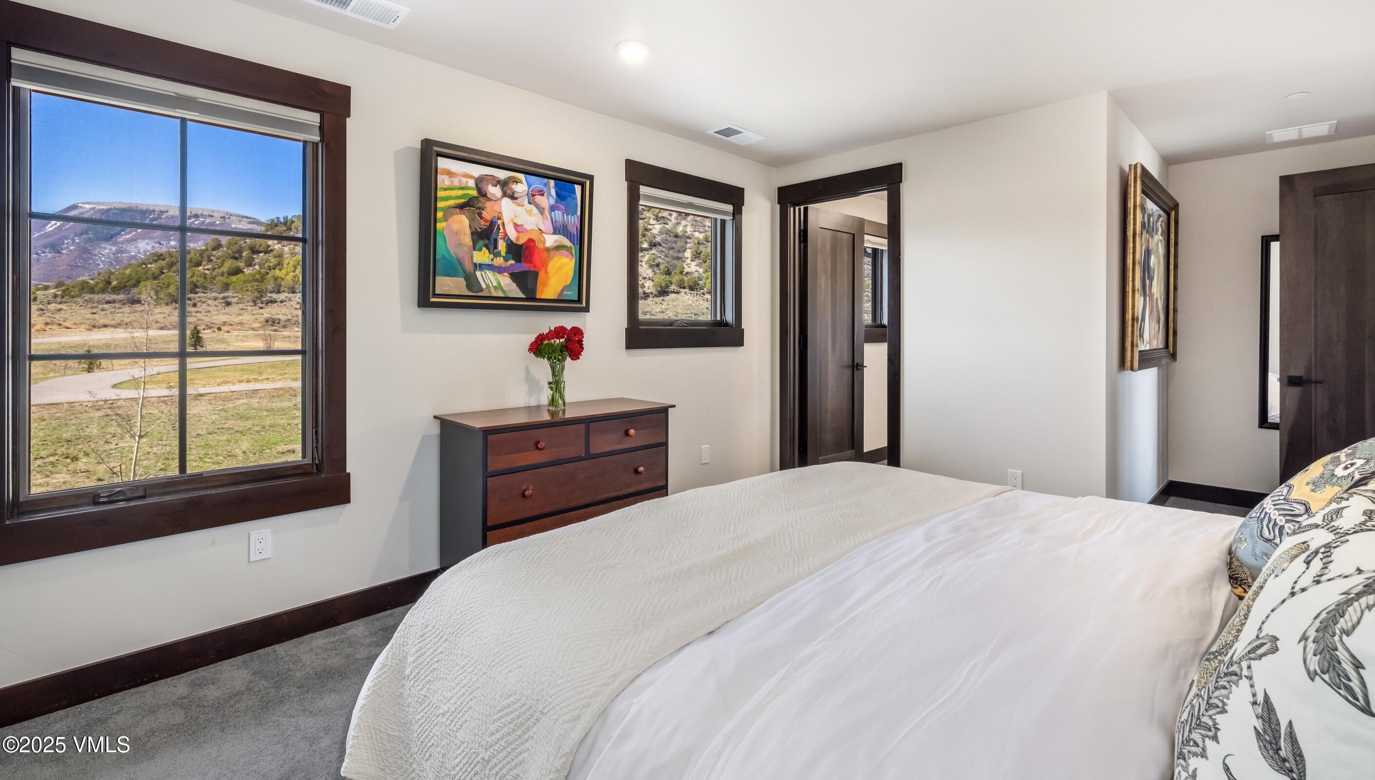 140 Hunters View Lane Eagle, CO 81631 - Photo 20 of 38 a bedroom with a bed and a window