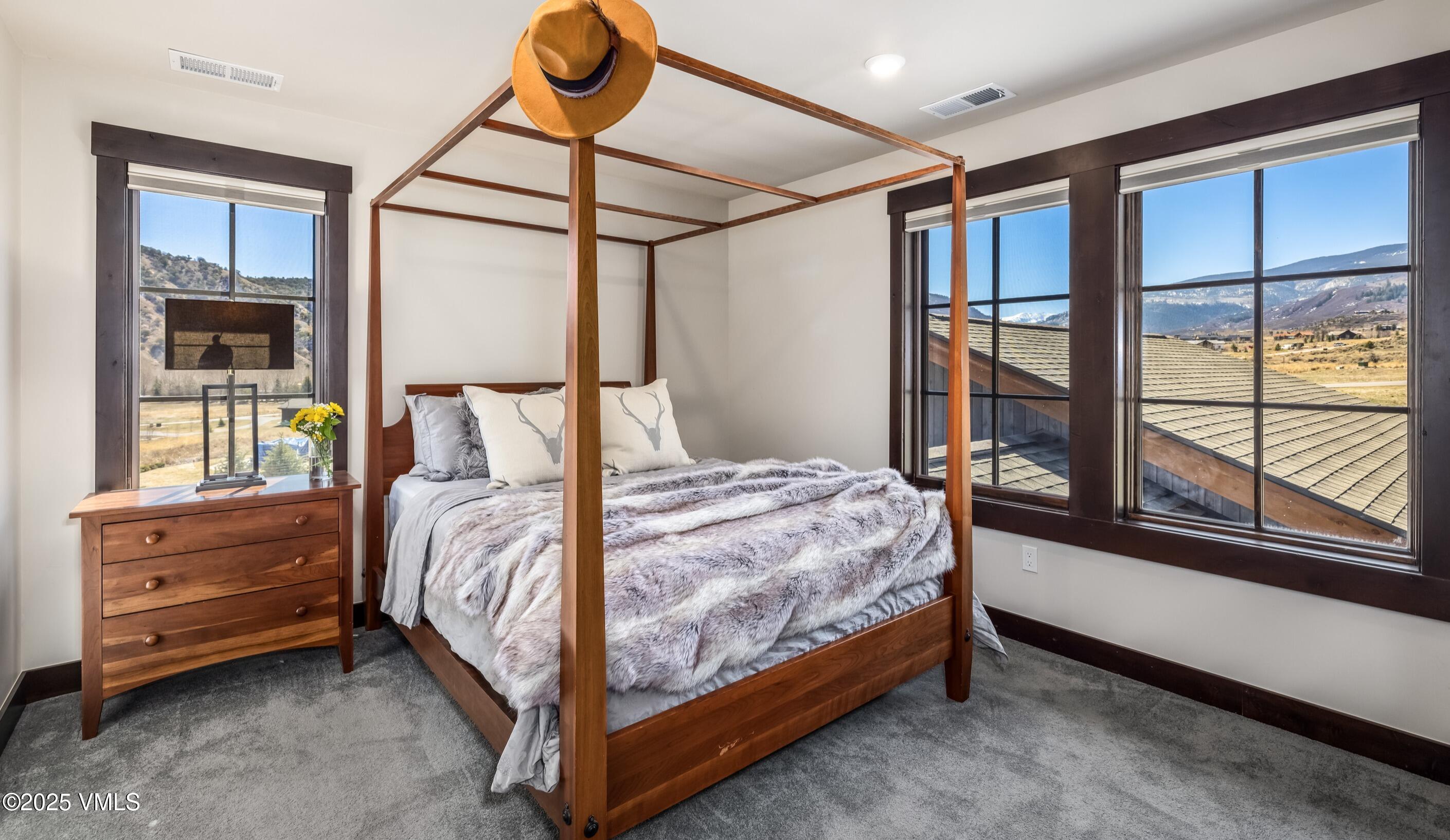 140 Hunters View Lane Eagle, CO 81631 - Photo 22 of 38 a bedroom with a bed and large window