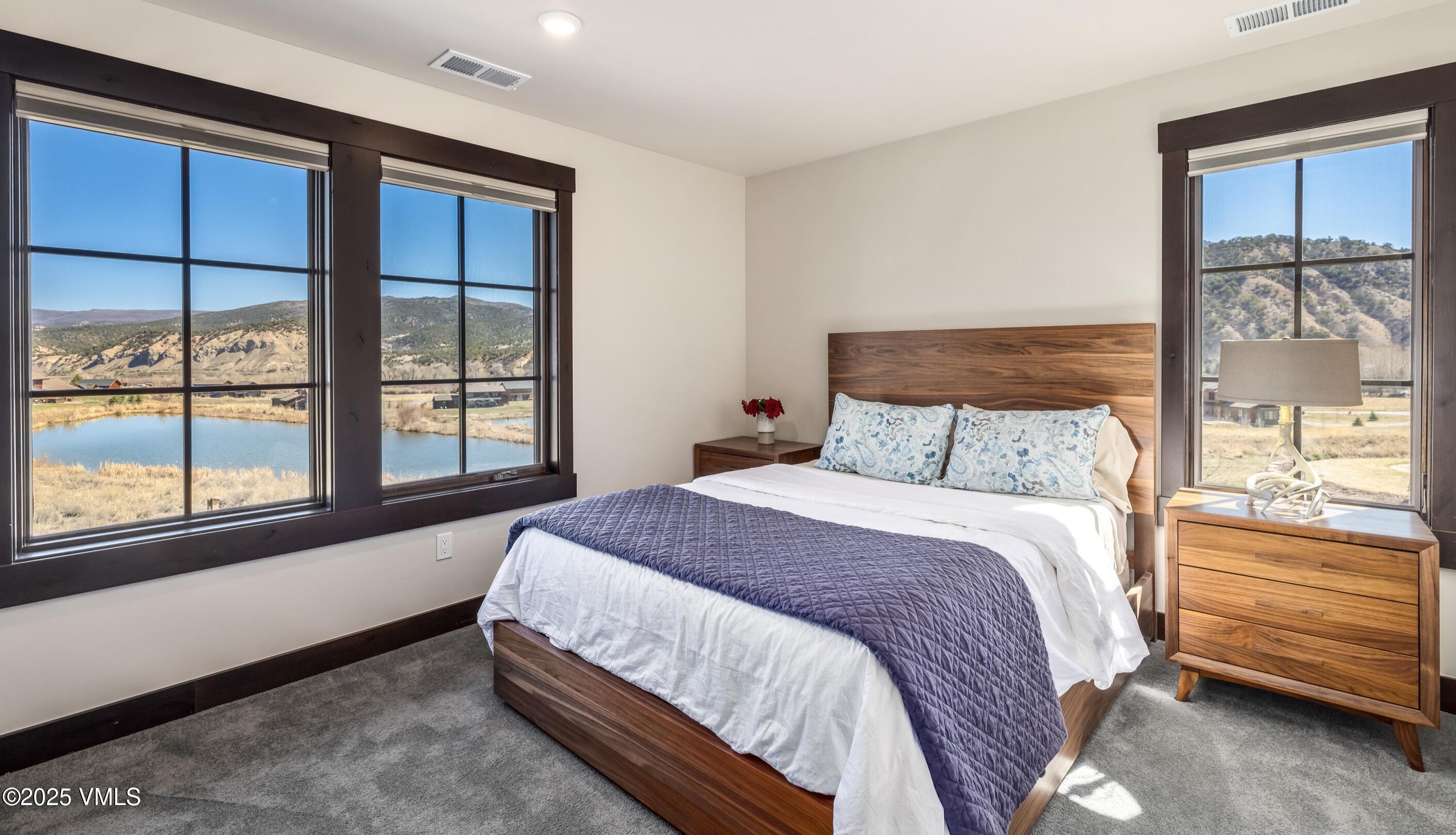 140 Hunters View Lane Eagle, CO 81631 - Photo 23 of 38 a bedroom with a bed and a window