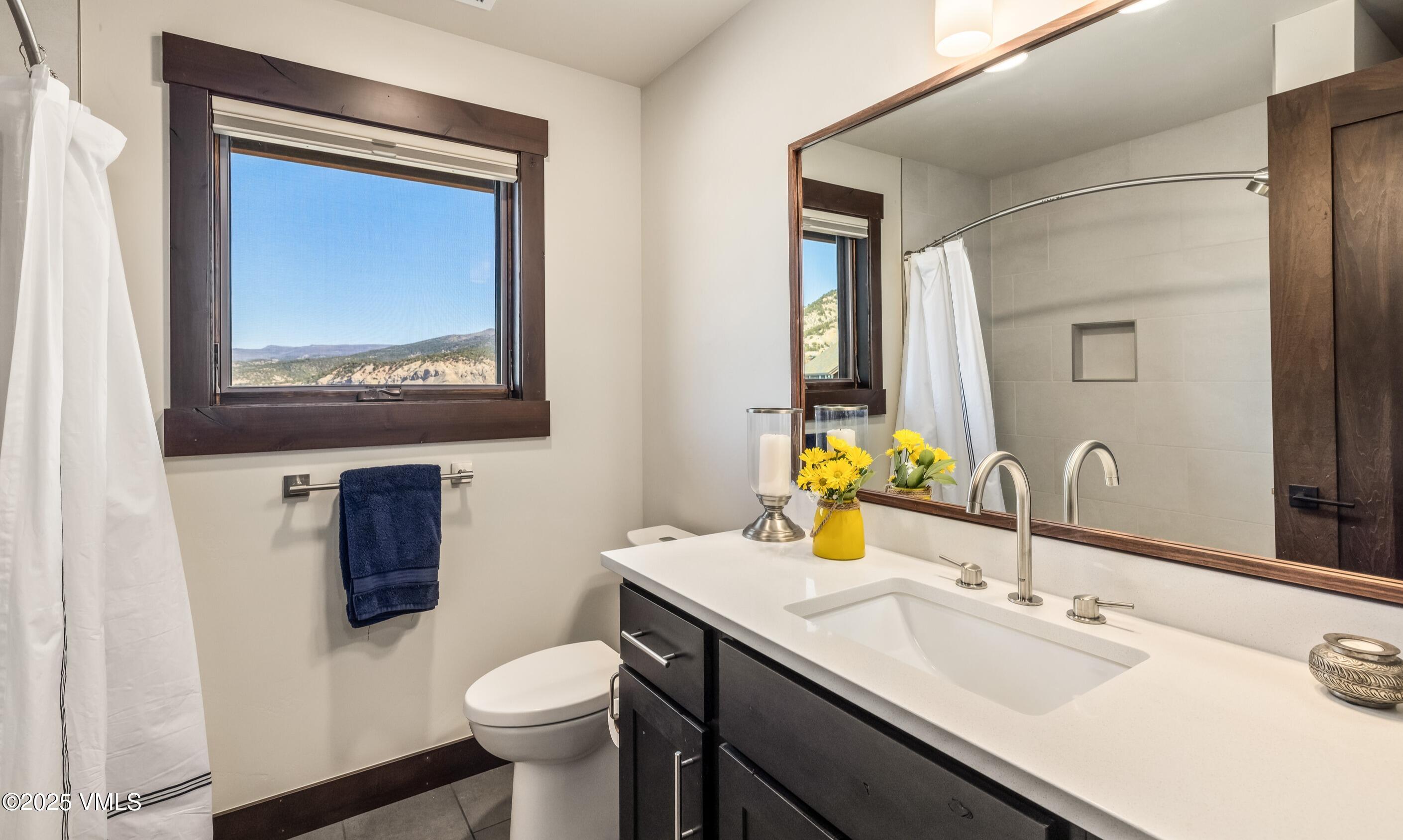 140 Hunters View Lane Eagle, CO 81631 - Photo 24 of 38 a bathroom with a toilet sink and mirror