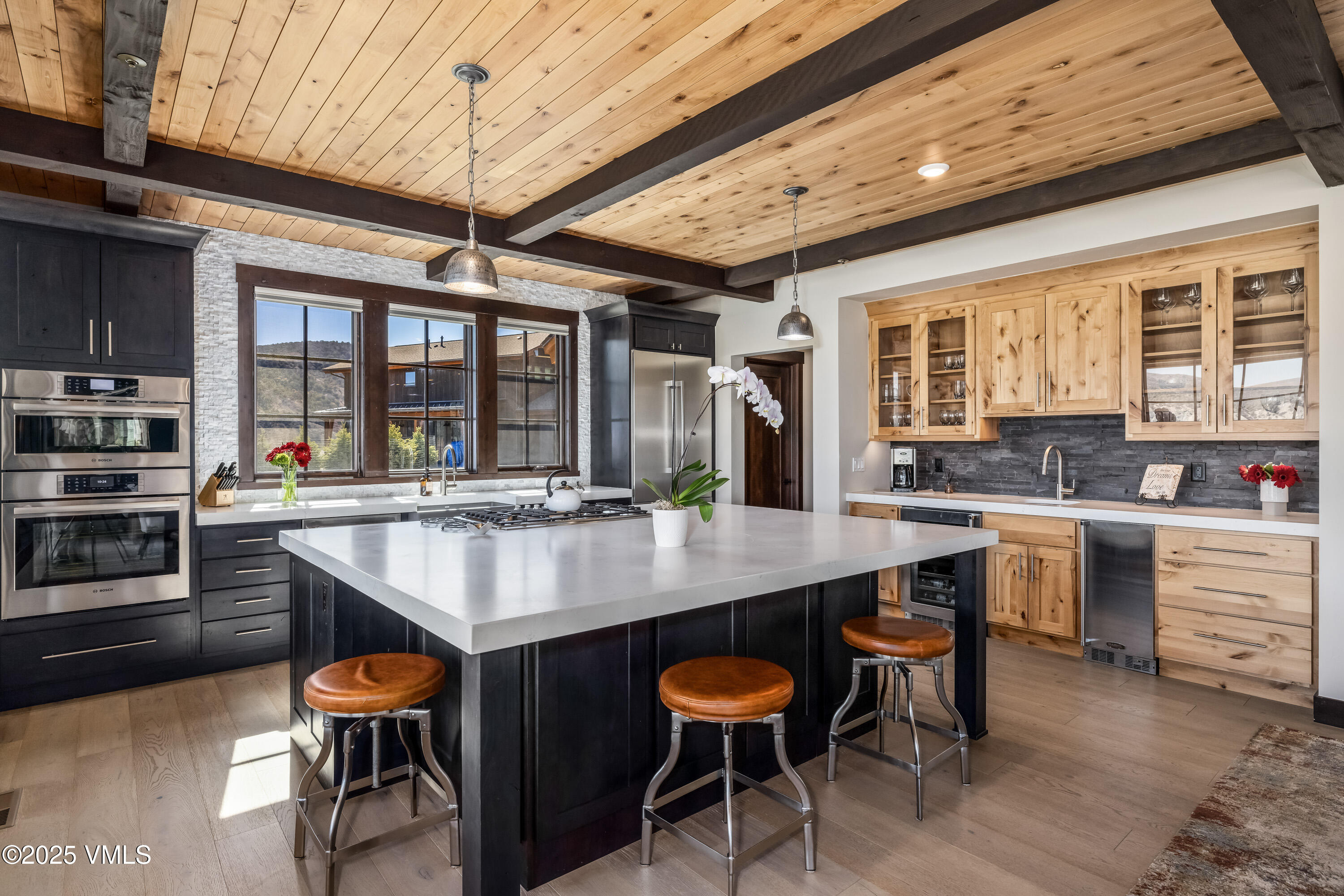 140 Hunters View Lane Eagle, CO 81631 - Photo 6 of 38 a kitchen with stainless steel appliances granite countertop table chairs and wooden cabinets