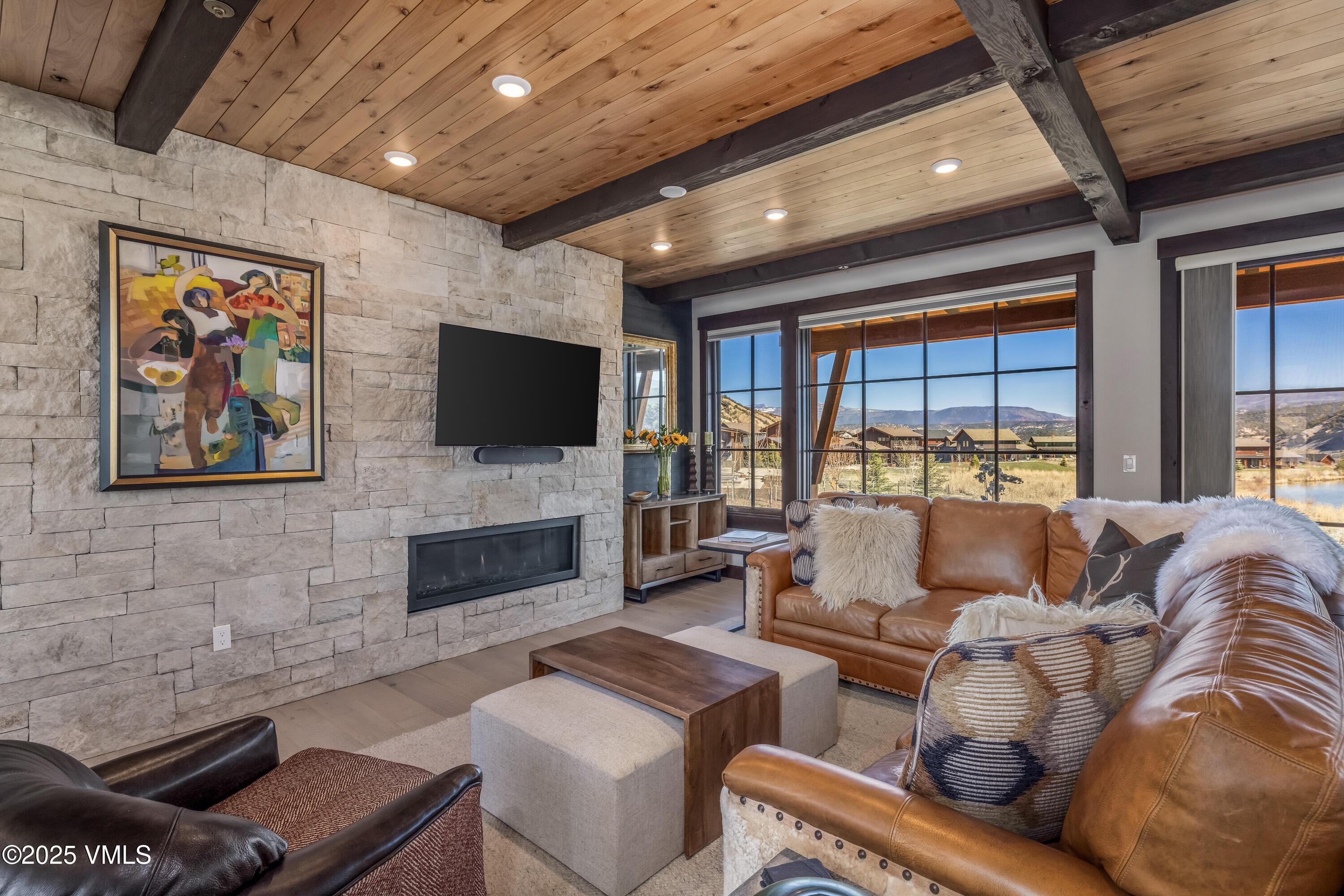140 Hunters View Lane Eagle, CO 81631 - Photo 8 of 38 a living room with furniture flat screen tv and a fireplace
