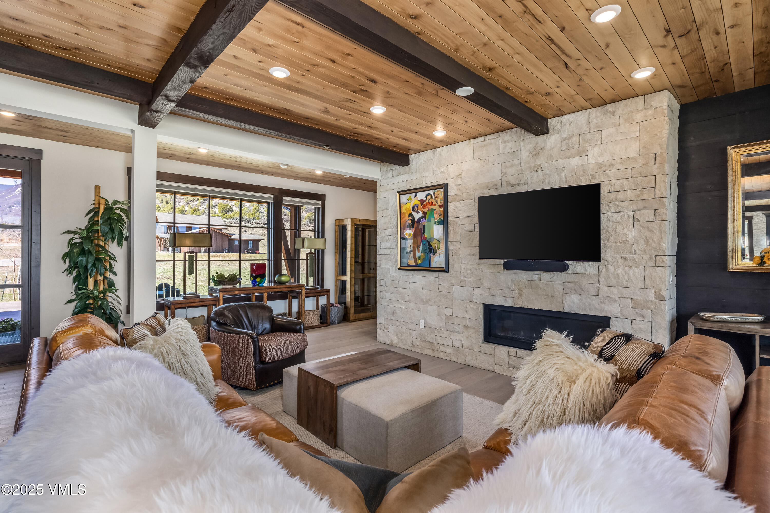 140 Hunters View Lane Eagle, CO 81631 - Photo 9 of 38 a living room with fireplace furniture and a flat screen tv