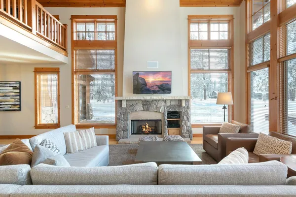 a living room with furniture window and a fireplace