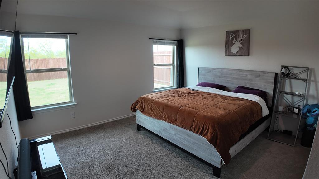1215 Rustic Vw Lane Denton, TX 76207 - Photo 12 of 25 a bed sitting in a bedroom next to a window