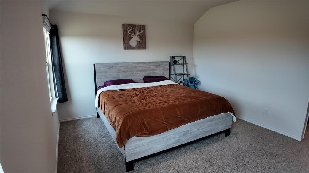 1215 Rustic Vw Lane Denton, TX 76207 - Photo 13 of 25 a bed sitting in a bedroom next to a small bathroom