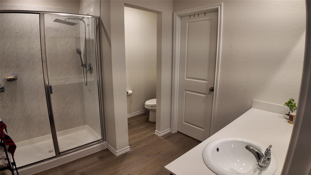 1215 Rustic Vw Lane Denton, TX 76207 - Photo 14 of 25 a bathroom with a granite countertop sink toilet and shower