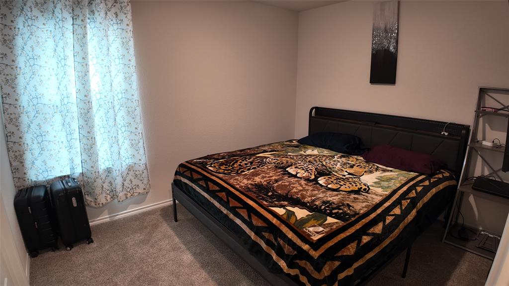 1215 Rustic Vw Lane Denton, TX 76207 - Photo 16 of 25 a bed sitting in a bedroom next to a window