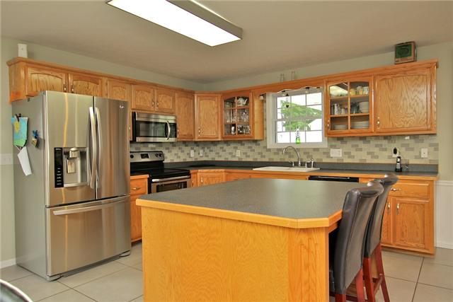 3582 Sweethome Road Ashland City, TN 37015 - Photo 11 of 18 Stainless appliances and mosaic glass tile backsplash