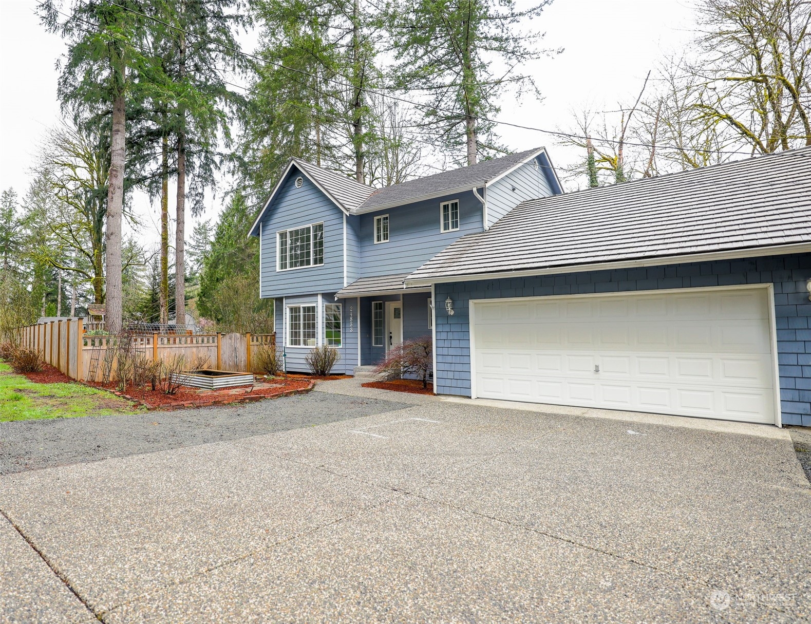24833 Florence Acres Road Monroe, WA 98272 - Photo 3 of 21 a front view of a house with a yard and garage