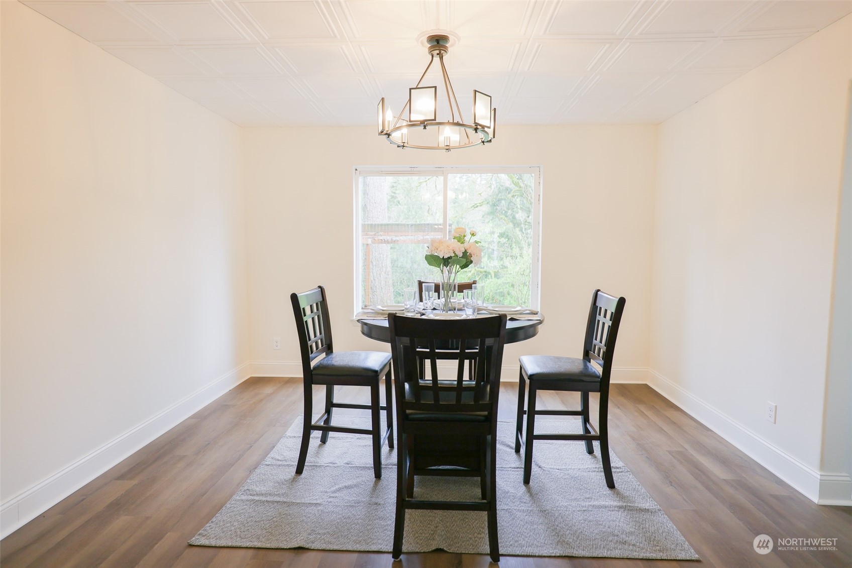 24833 Florence Acres Road Monroe, WA 98272 - Photo 5 of 21 a dining room with furniture a chandelier and wooden floor